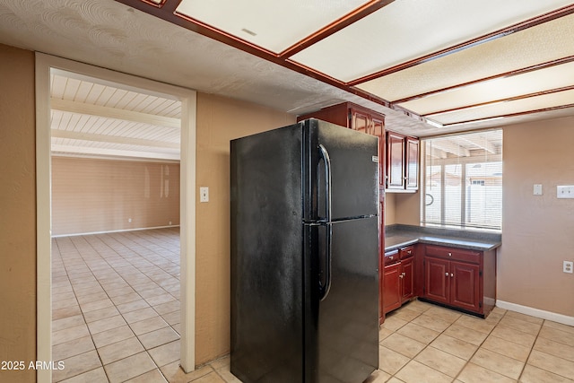 kitchen featuring black refrigerator and light tile patterned floors