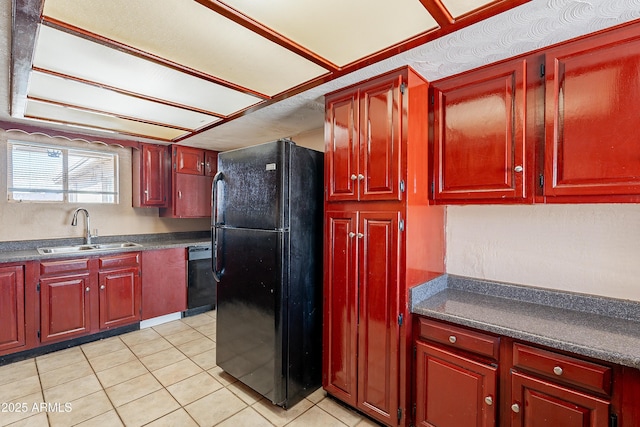 kitchen featuring sink, black appliances, and light tile patterned flooring