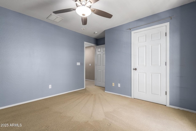 unfurnished bedroom with ceiling fan, carpet floors, visible vents, and baseboards