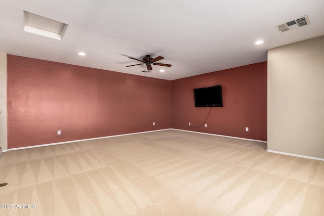 spare room featuring attic access, recessed lighting, visible vents, and light carpet