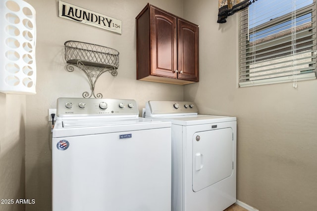 clothes washing area with cabinet space and independent washer and dryer