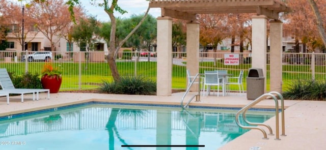 pool with a patio area, fence, and a pergola