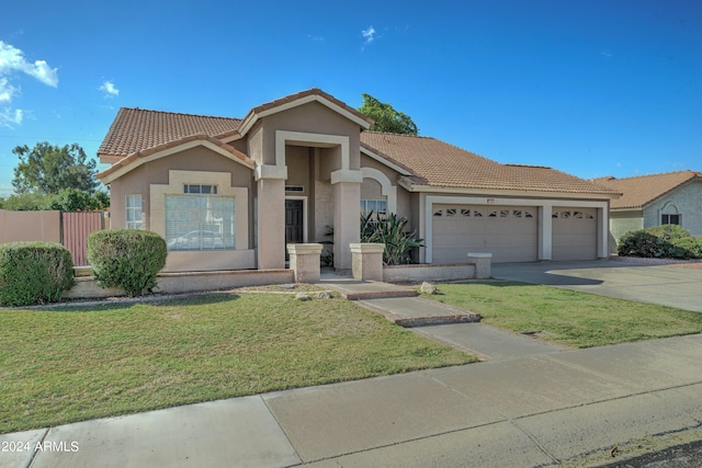 view of front of house with a front lawn and a garage