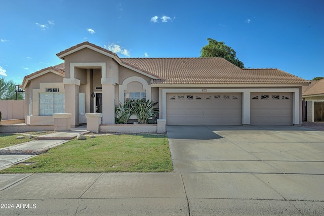 view of front facade with a garage and a front lawn