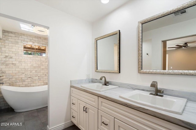 full bathroom with double vanity, a soaking tub, visible vents, and a sink