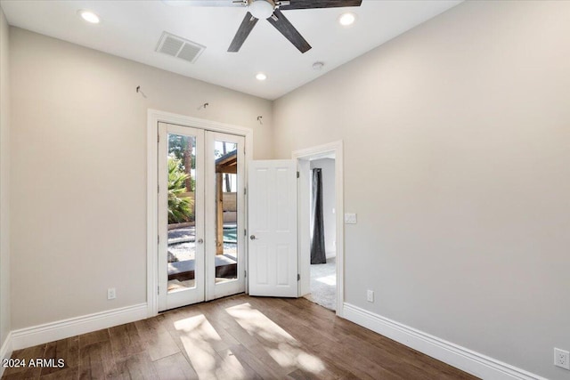 empty room with ceiling fan, french doors, visible vents, and wood finished floors