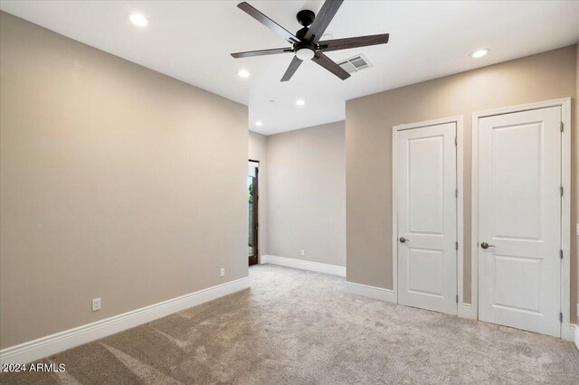 unfurnished bedroom featuring visible vents, recessed lighting, carpet, and baseboards