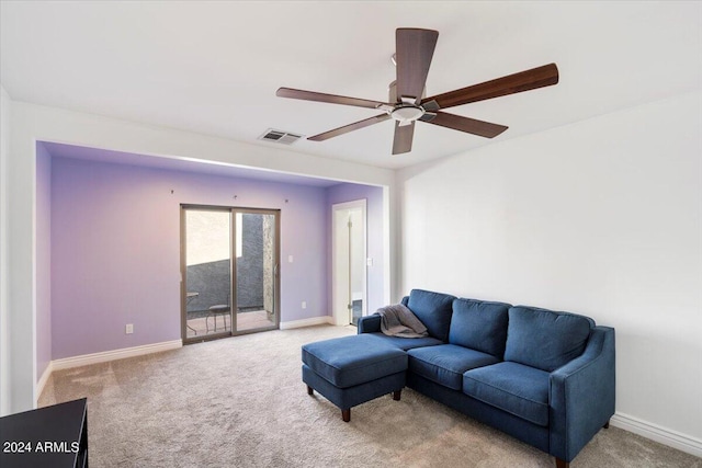 carpeted living area featuring visible vents, baseboards, and ceiling fan