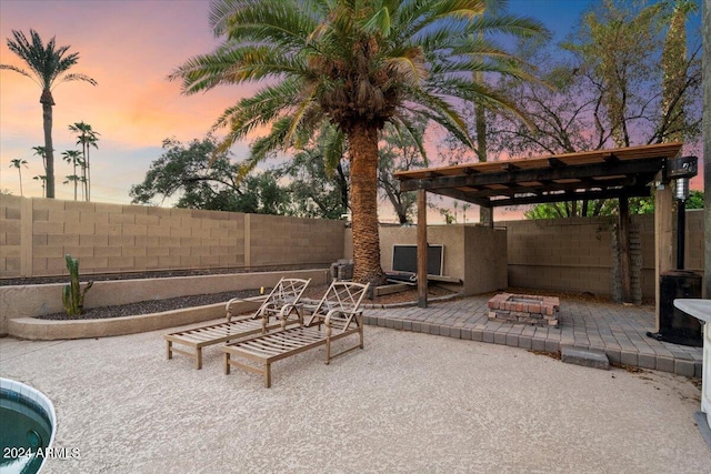 view of patio / terrace with an outdoor fire pit, a fenced backyard, and a pergola