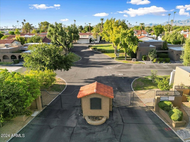 view of road featuring a residential view and a gate