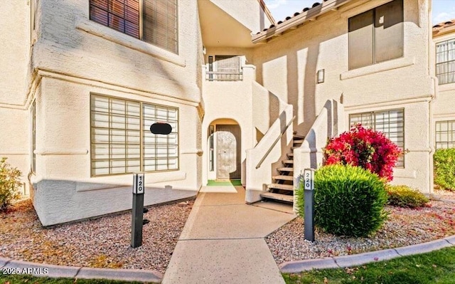 entrance to property featuring stucco siding