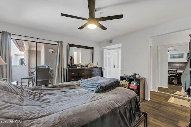 bedroom featuring baseboards, visible vents, ceiling fan, and wood finished floors