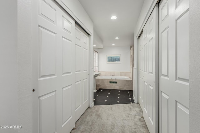 corridor with tile patterned floors, carpet, and recessed lighting