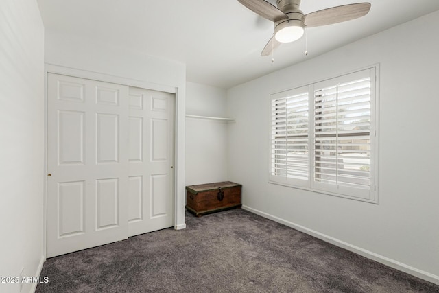 unfurnished bedroom with a closet, a ceiling fan, carpet, and baseboards