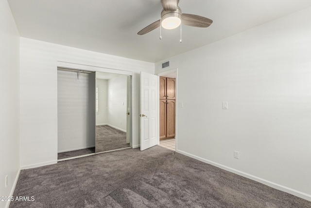 unfurnished bedroom featuring carpet floors, baseboards, visible vents, and a closet