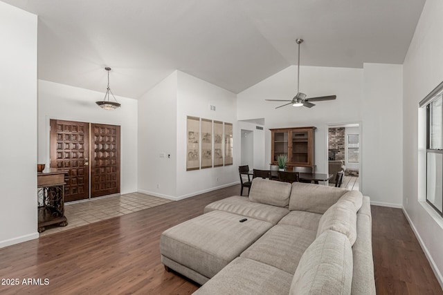 living room with high vaulted ceiling, ceiling fan, wood finished floors, and visible vents