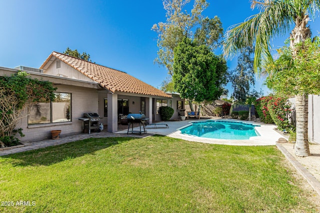 view of swimming pool with a lawn, a fenced in pool, a fenced backyard, a patio, and a grill