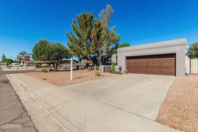 view of front facade featuring a garage, stucco siding, and driveway
