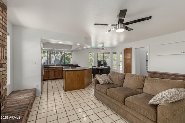 living room with a ceiling fan, recessed lighting, and light tile patterned floors