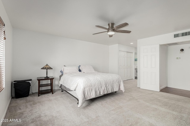 bedroom featuring carpet floors, ceiling fan, visible vents, and a closet
