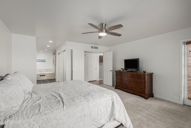 bedroom featuring visible vents, carpet floors, baseboards, a ceiling fan, and ensuite bath