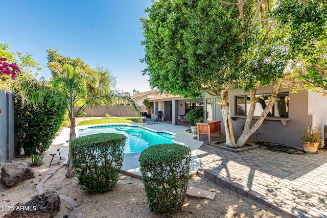 view of pool with a fenced in pool and a patio