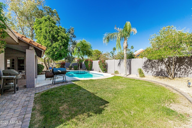 view of yard featuring a fenced in pool, a fenced backyard, and a patio area