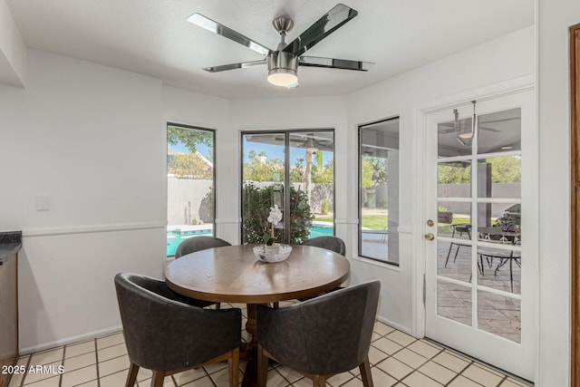 dining area featuring ceiling fan and light tile patterned flooring