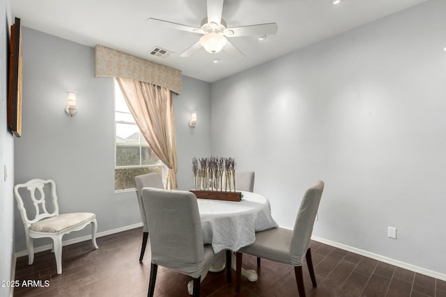 dining area featuring a ceiling fan, wood finished floors, visible vents, and baseboards