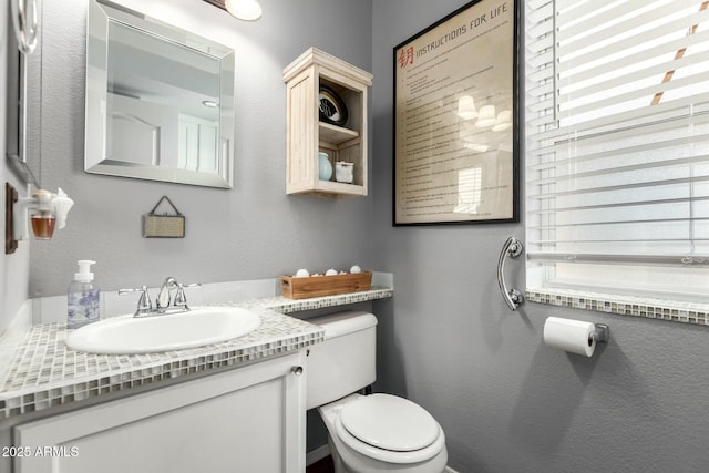 half bathroom with toilet and vanity