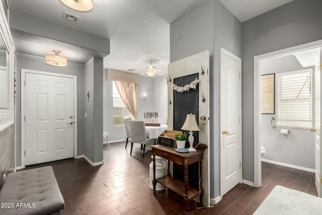 entrance foyer featuring dark wood-style floors, visible vents, and baseboards