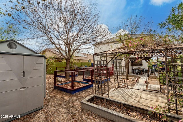 view of yard with a deck, an outdoor structure, and a vegetable garden