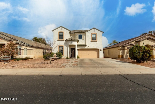 french country home with a garage, concrete driveway, and stucco siding