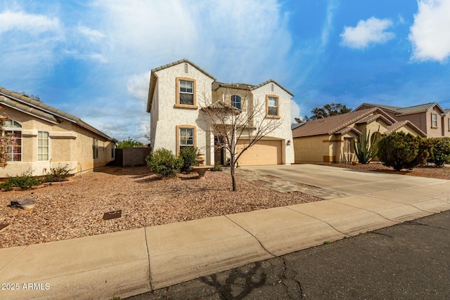 view of front facade with stucco siding, concrete driveway, an attached garage, and fence