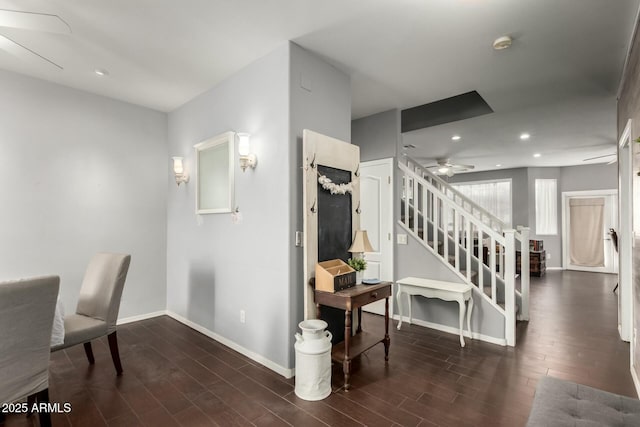 interior space with wood finished floors, recessed lighting, baseboards, ceiling fan, and stairs