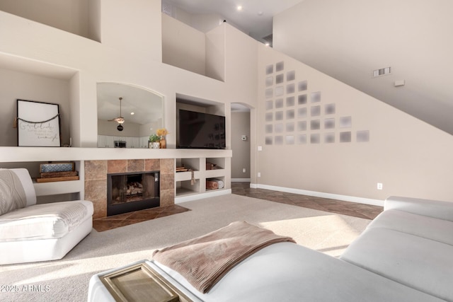 7029 E Monte Cir, Mesa, AZ 85209 - living area featuring a towering ceiling, baseboards, a tiled fireplace, and carpet floors
