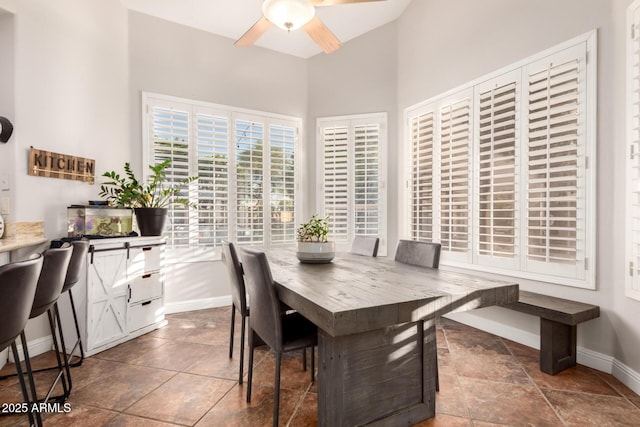 7029 E Monte Cir, Mesa, AZ 85209 - dining space featuring ceiling fan, baseboards, and a towering ceiling