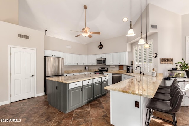 7029 E Monte Cir, Mesa, AZ 85209 - kitchen featuring stainless steel appliances, gray cabinetry, ceiling fan, a sink, and white cabinetry