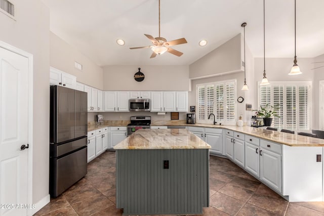 7029 E Monte Cir, Mesa, AZ 85209 - kitchen with appliances with stainless steel finishes, a peninsula, ceiling fan, white cabinets, and light stone countertops