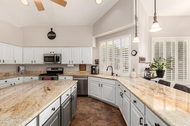 7029 E Monte Cir, Mesa, AZ 85209 - kitchen with stainless steel appliances, a sink, white cabinetry, ceiling fan, and a high ceiling