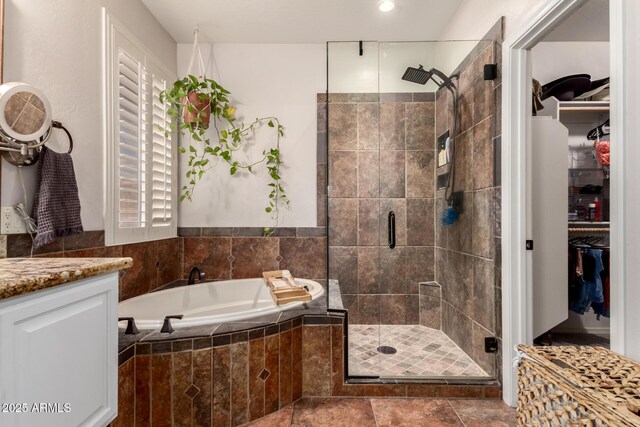 7029 E Monte Cir, Mesa, AZ 85209 - bathroom featuring a garden tub, a shower stall, a spacious closet, and vanity