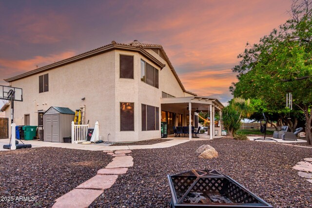 7029 E Monte Cir, Mesa, AZ 85209 - back of house featuring a fire pit, a patio, a ceiling fan, stucco siding, and a fenced backyard