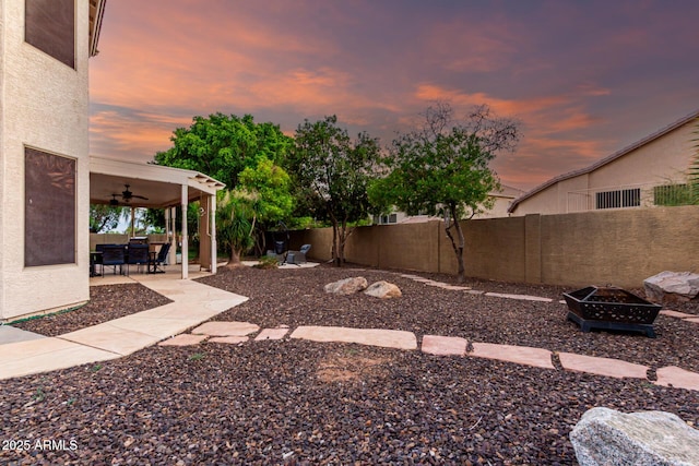 7029 E Monte Cir, Mesa, AZ 85209 - fenced backyard with a fire pit, a ceiling fan, and a patio area