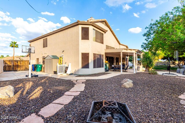 7029 E Monte Cir, Mesa, AZ 85209 - rear view of house with a fire pit, a patio, stucco siding, and a ceiling fan