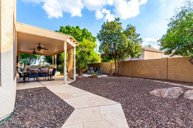 7029 E Monte Cir, Mesa, AZ 85209 - fenced backyard featuring ceiling fan, an outdoor hangout area, and a patio area