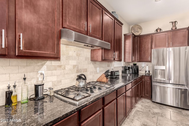 20532 W Summit Pl, Buckeye, AZ 85396 - kitchen with stainless steel appliances, under cabinet range hood, backsplash, and dark stone countertops