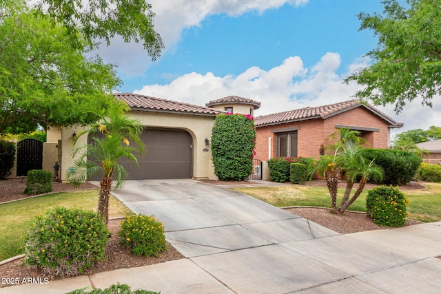 20532 W Summit Pl, Buckeye, AZ 85396 - mediterranean / spanish home featuring a tile roof, a garage, driveway, and stucco siding