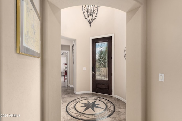 20532 W Summit Pl, Buckeye, AZ 85396 - foyer entrance featuring inlaid floor details, baseboards, and a chandelier