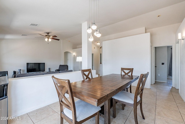 dining space with lofted ceiling, light tile patterned floors, and ceiling fan