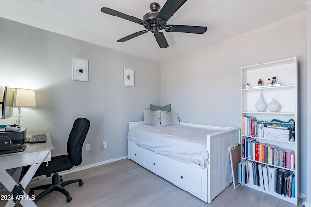 bedroom with light hardwood / wood-style flooring and ceiling fan